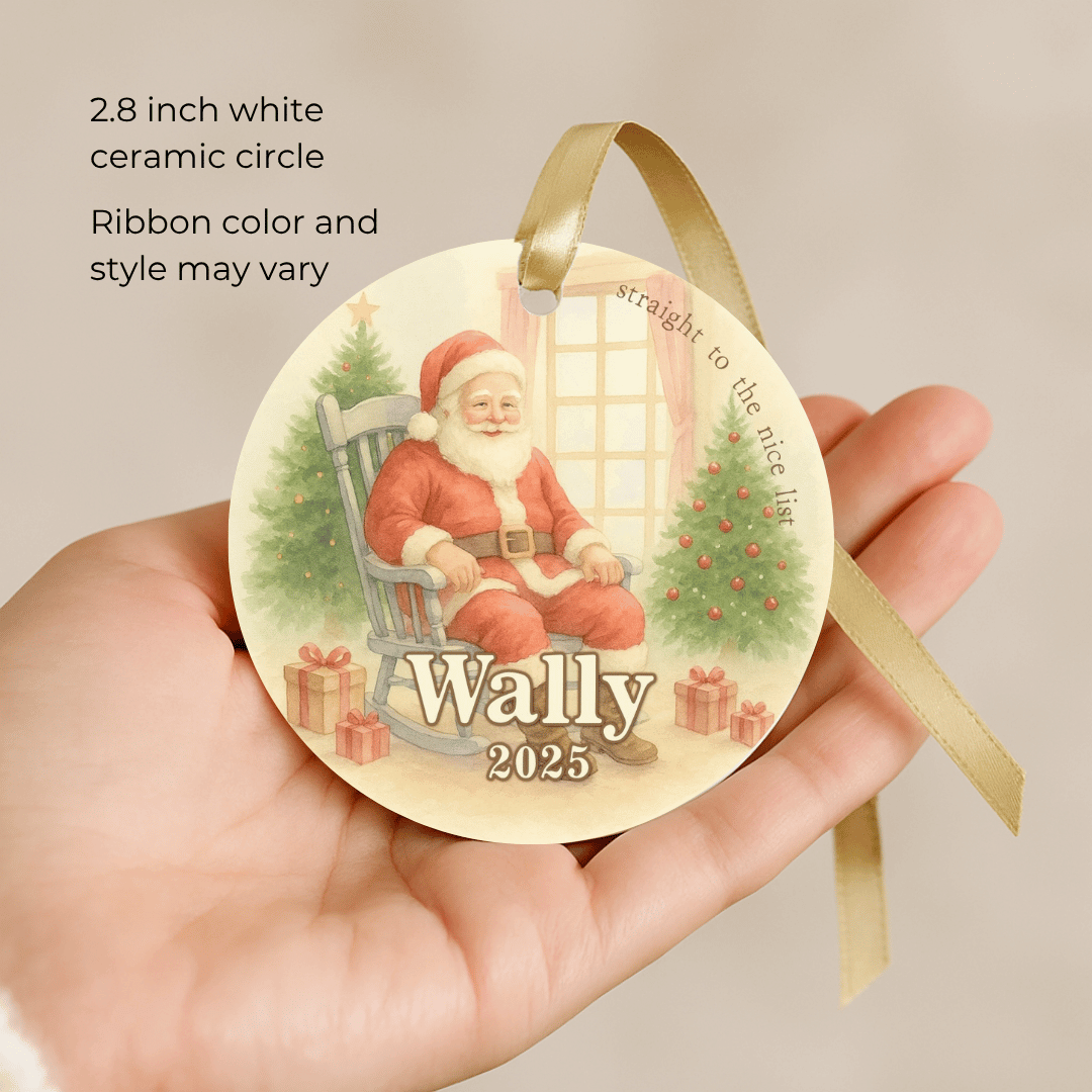 Round ceramic Christmas ornament with Santa Claus design held in a hand, on a beige background.