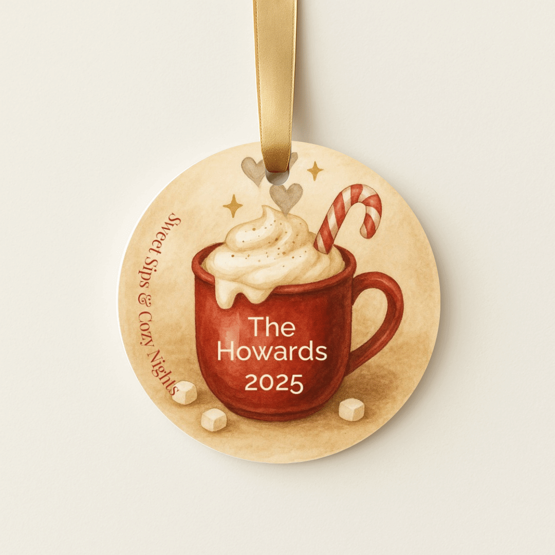 Personalized Christmas ornament with a red mug, whipped cream, and candy cane on a beige background.
