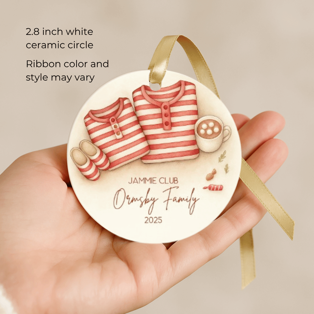 Decorative personalized ornament with matching Christmas family pajamas held by a hand