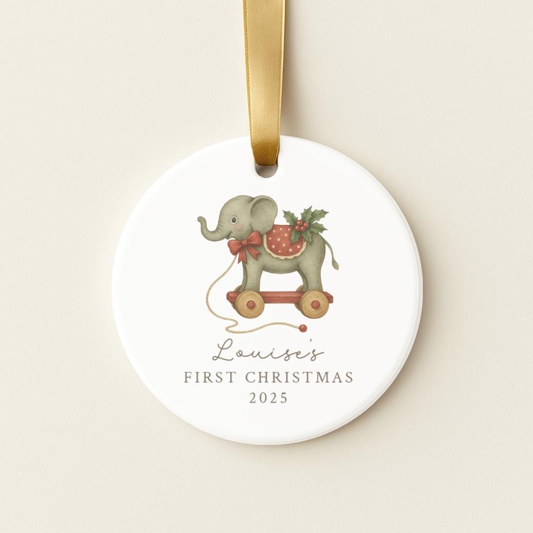 Round personalized ceramic ornament with an elephant pull toy for baby&