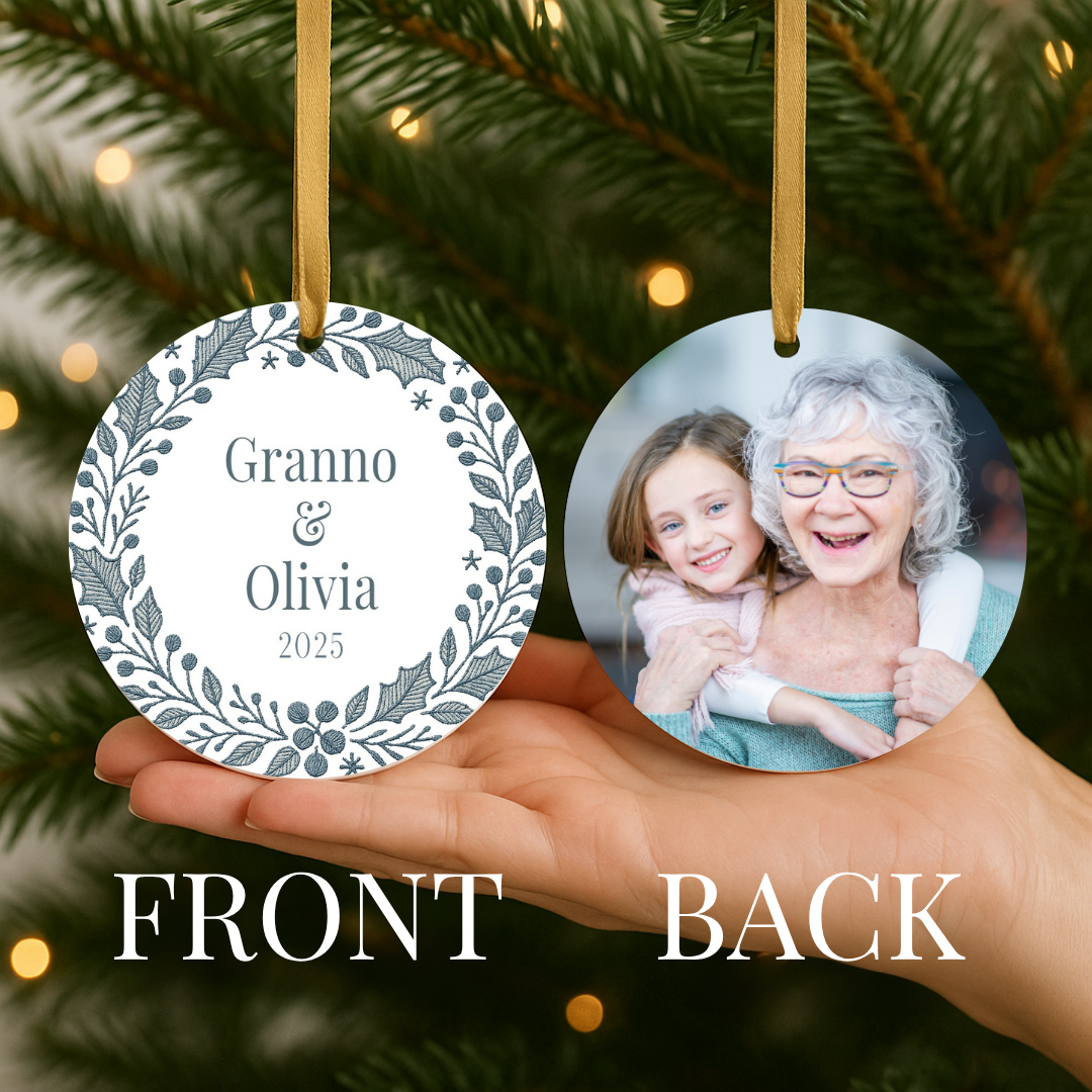 Personalized Christmas ornament with a blue embroidered wreath on the front and a photo on the back