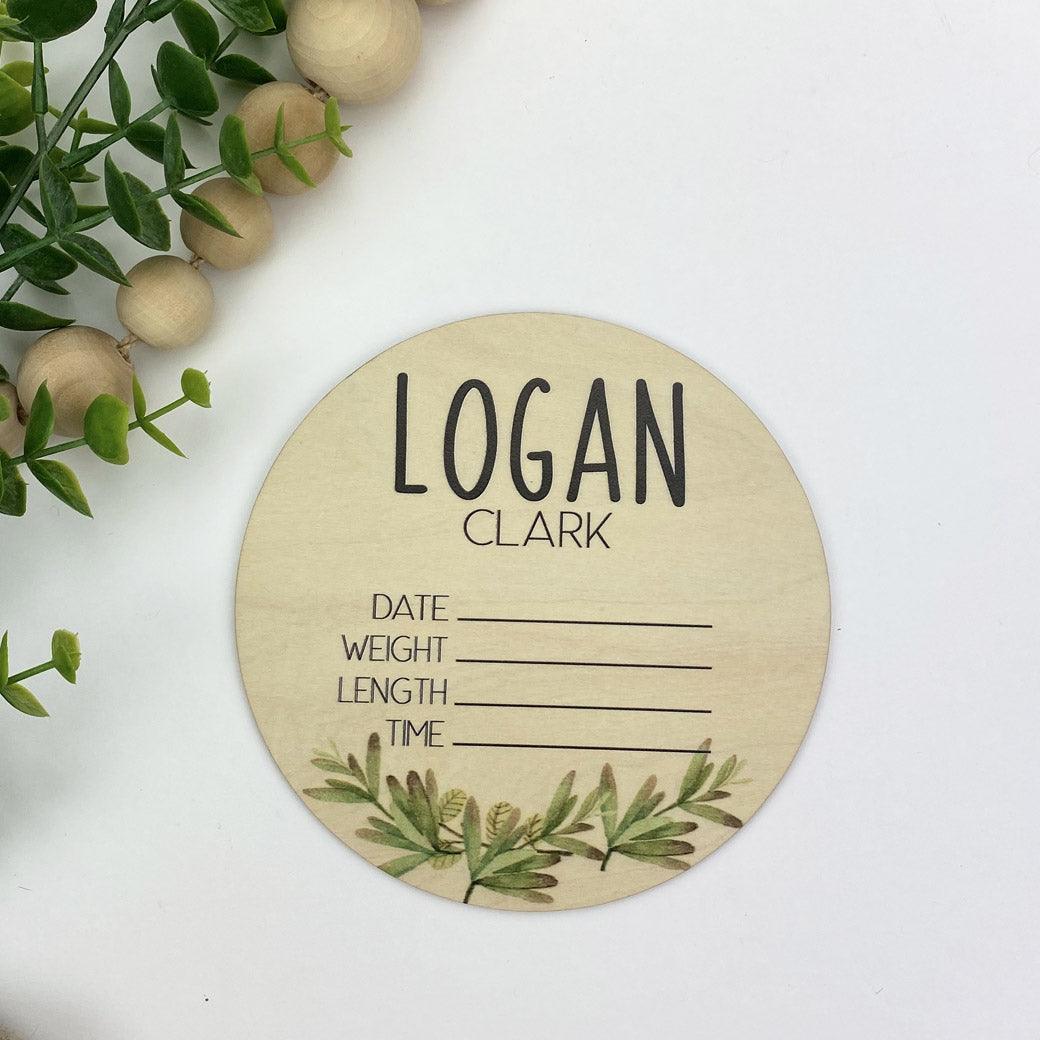 Wooden circle personalized with baby's name from Birchmark Designs, with room to record baby's birth stats