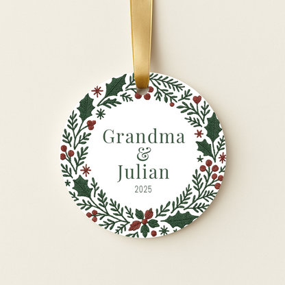 Round personalized Christmas ornament with a green and red embroidered wreath design