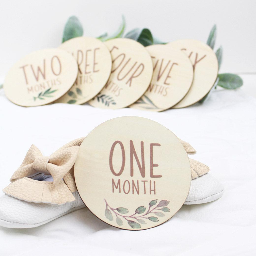 Six double-sided milestone discs from one-month to twelve-months from Birchmark Designs