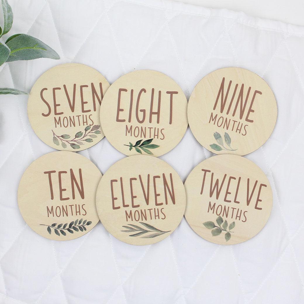 Six double-sided milestone discs from one-month to twelve-months from Birchmark Designs