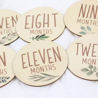 Six double-sided milestone discs from one-month to twelve-months from Birchmark Designs