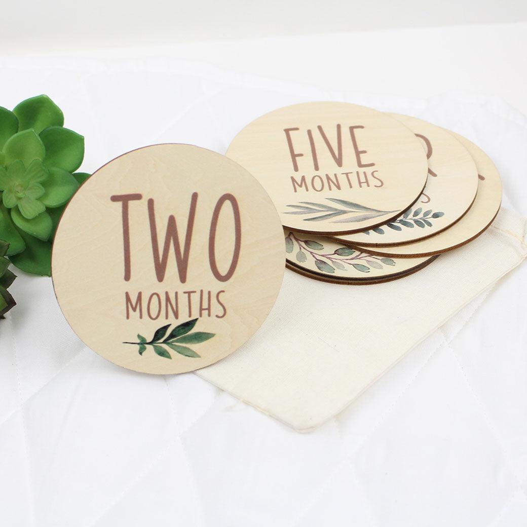 Six double-sided milestone discs from one-month to twelve-months from Birchmark Designs