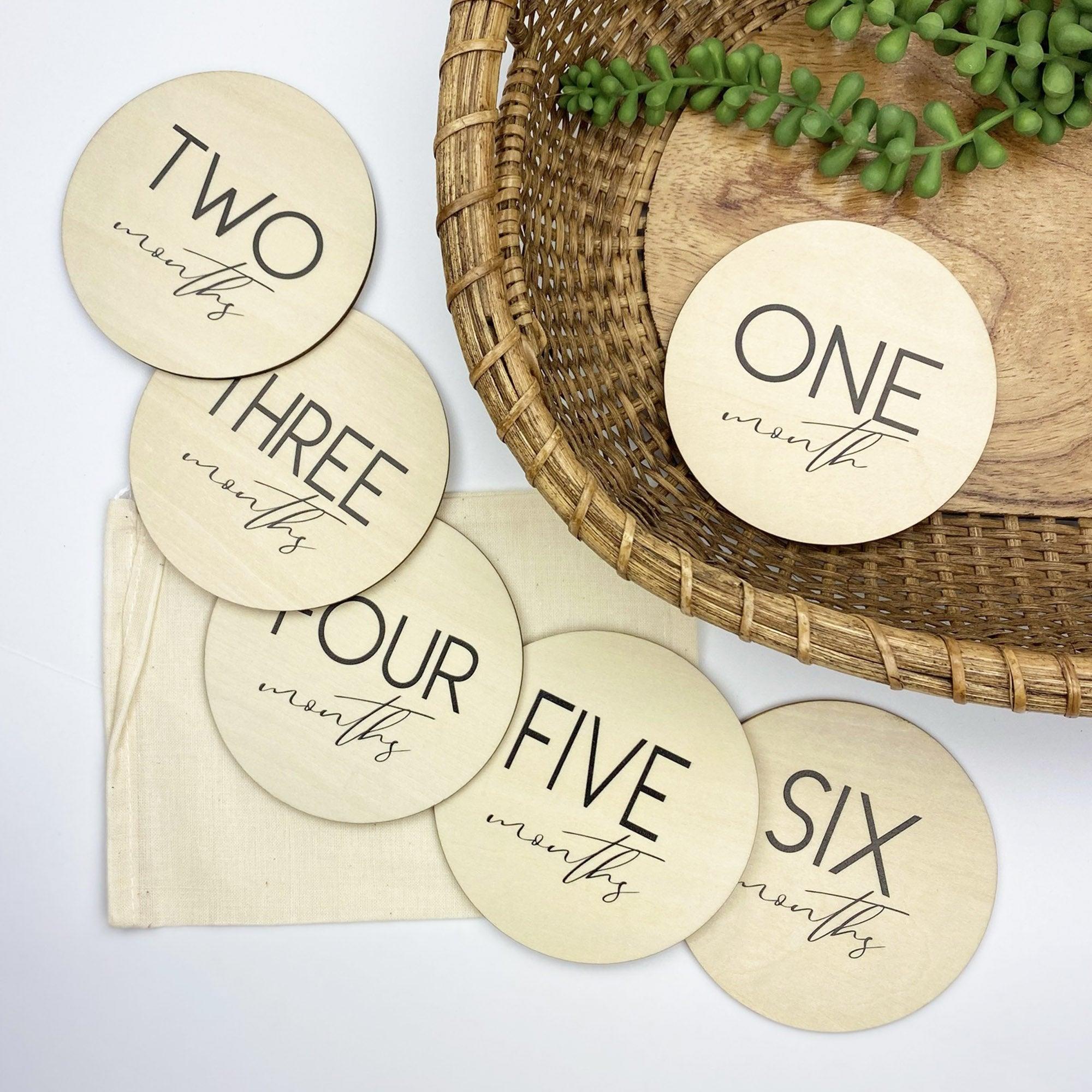 Baby milestone cards from Birchmark Designs showing one month to six months