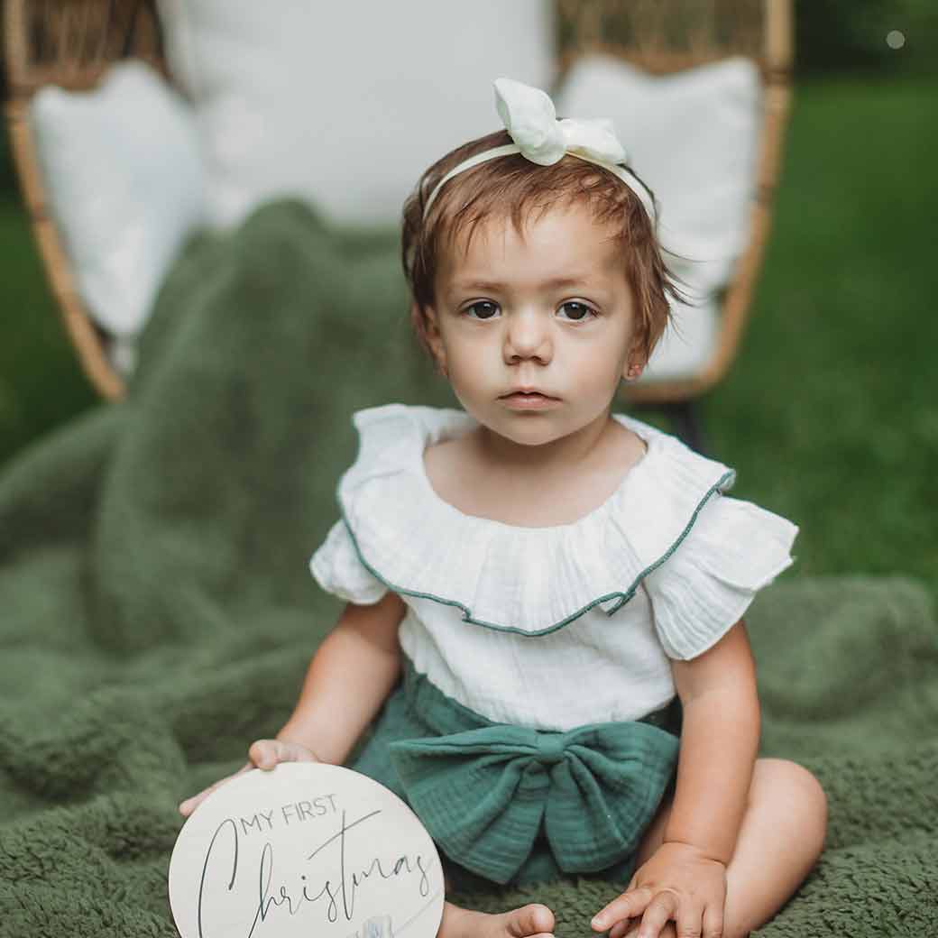 My First Christmas Feather Photo Prop by Birchmark Designs with serious baby