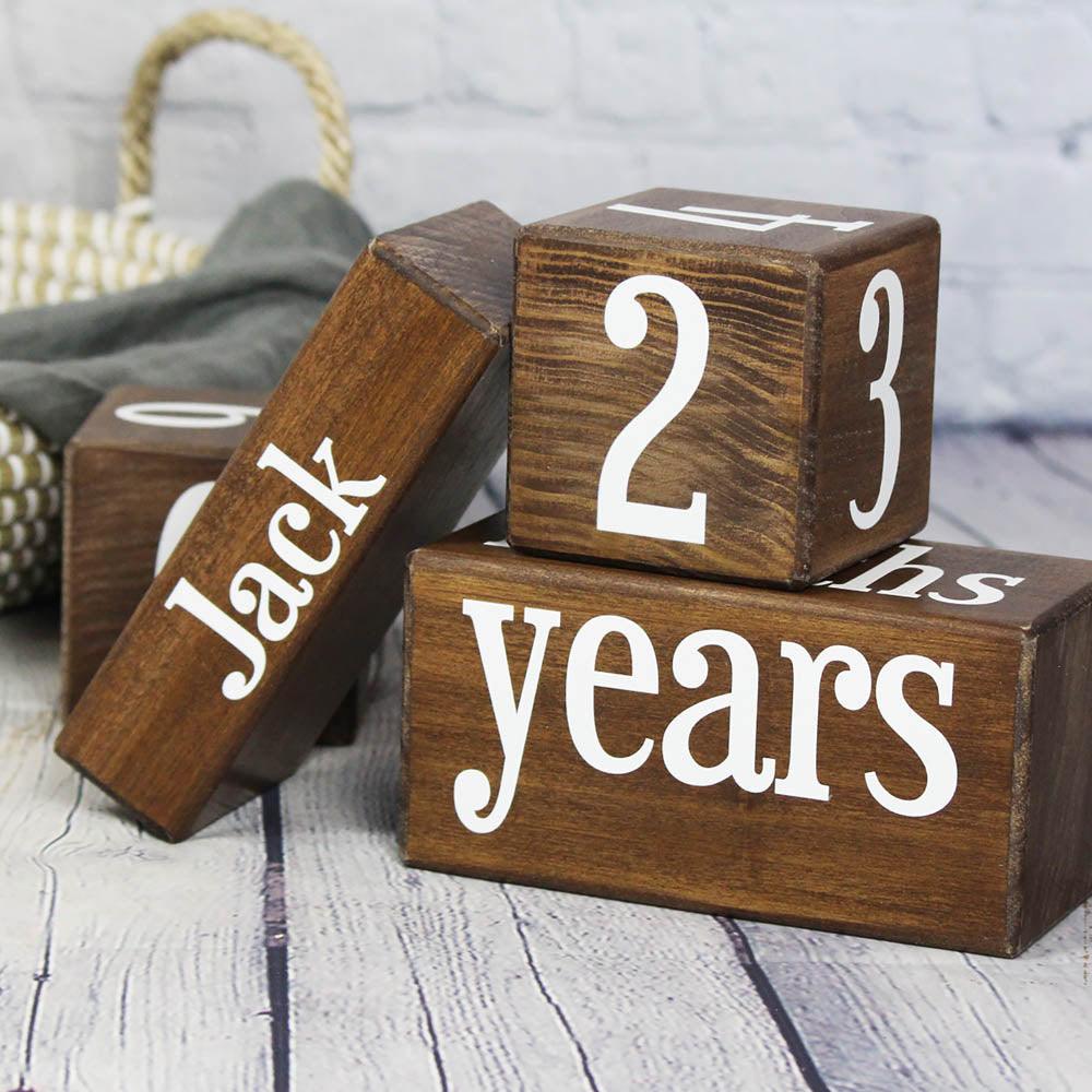 Hickory baby milestone blocks in walnut at 2 years with personalized name block