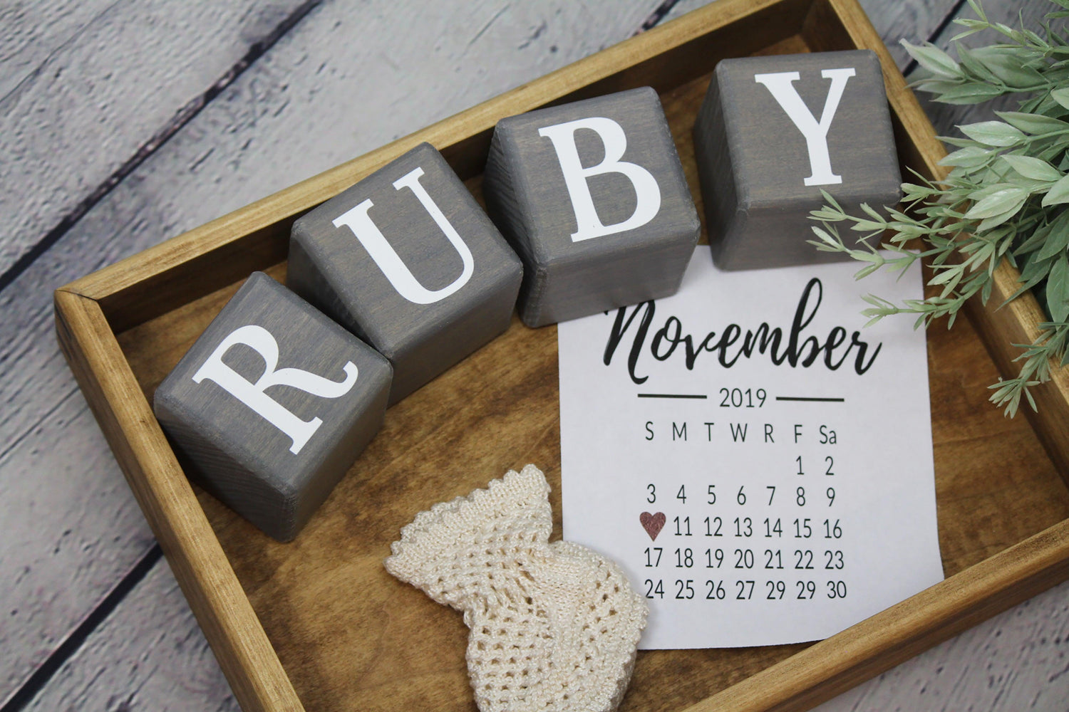 Wooden letter blocks in gray stain spelling Ruby