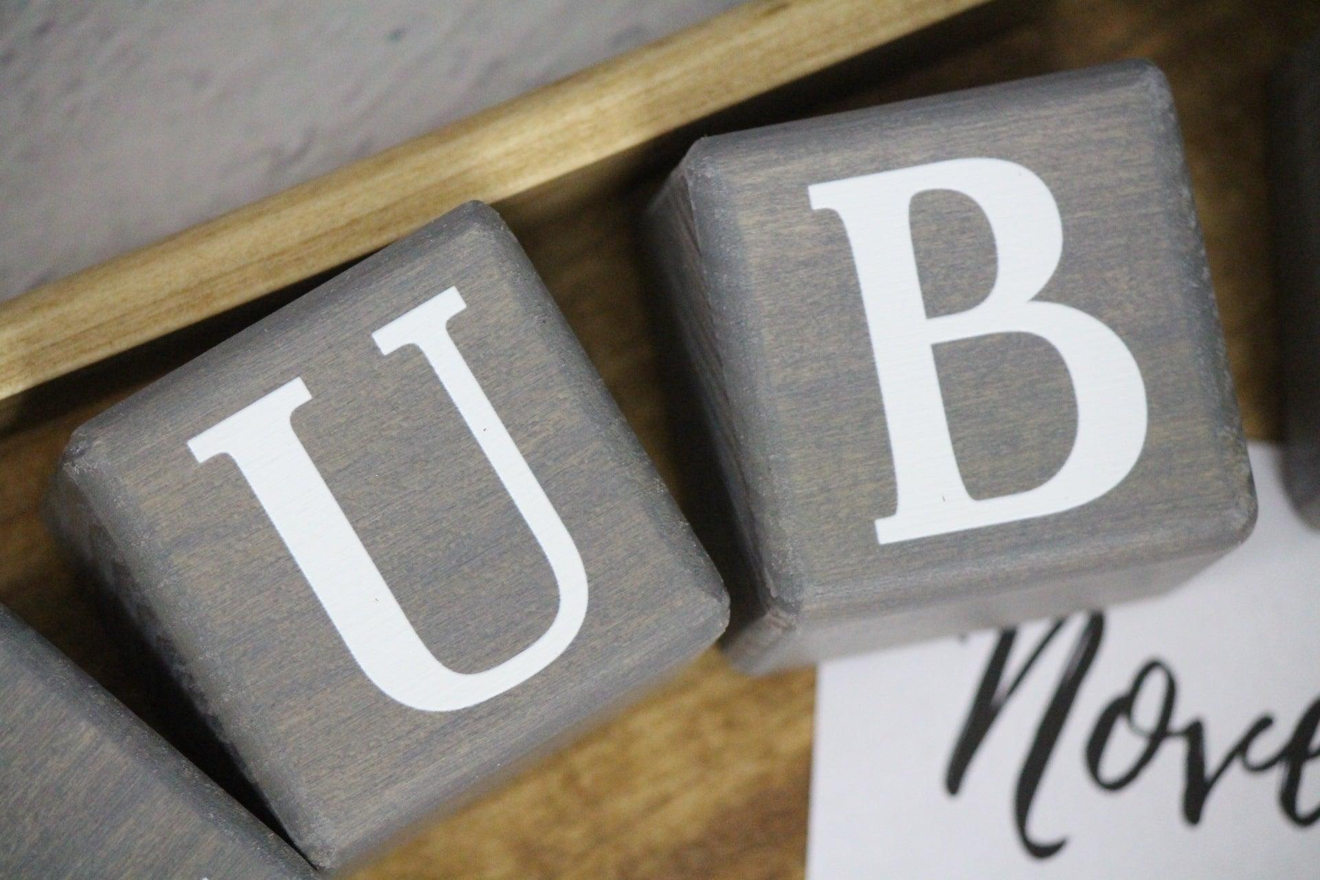 Close up of gray stain letter blocks