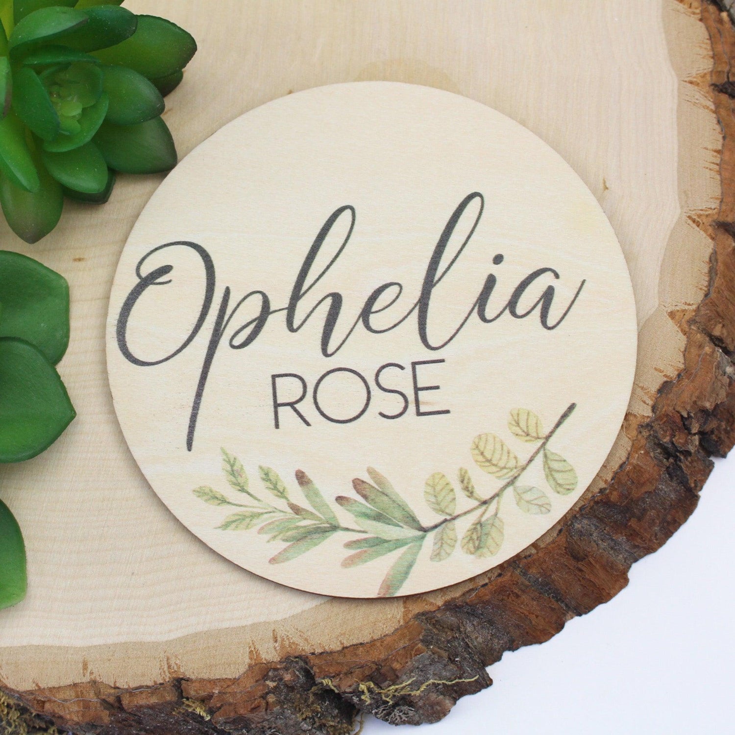 Name announcement sign with greenery design at the bottom