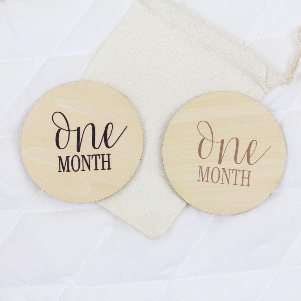 Simple baby monthly milestone cards showing 1 month in black and camel