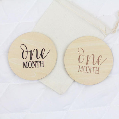 Simple baby monthly milestone cards showing 1 month in black and camel